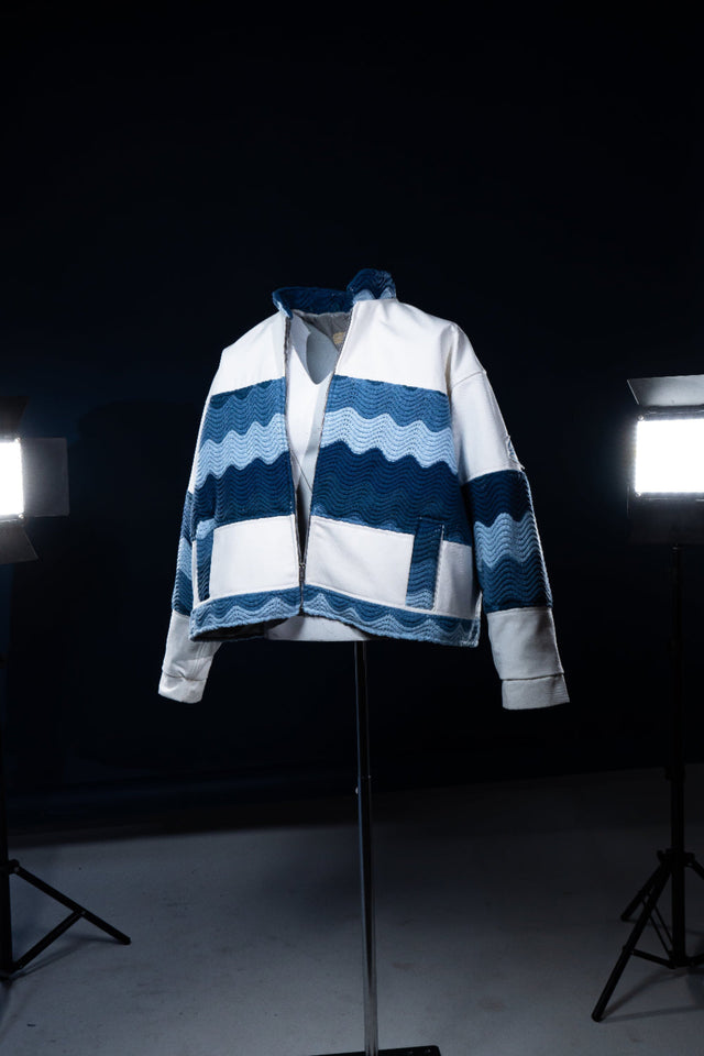 Blue and white patterned jacket on a mannequin against a dark background