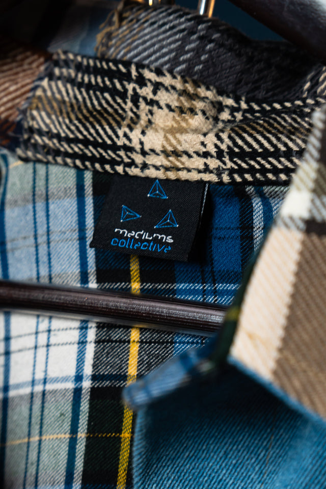 Plaid fabric with a visible Mediums collective brand label on a hanger