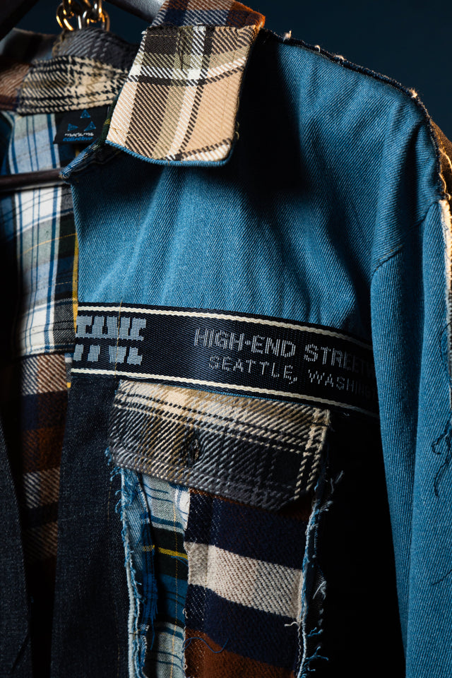 Blue jacket with plaid pattern and 'High-End Street' label on a dark background