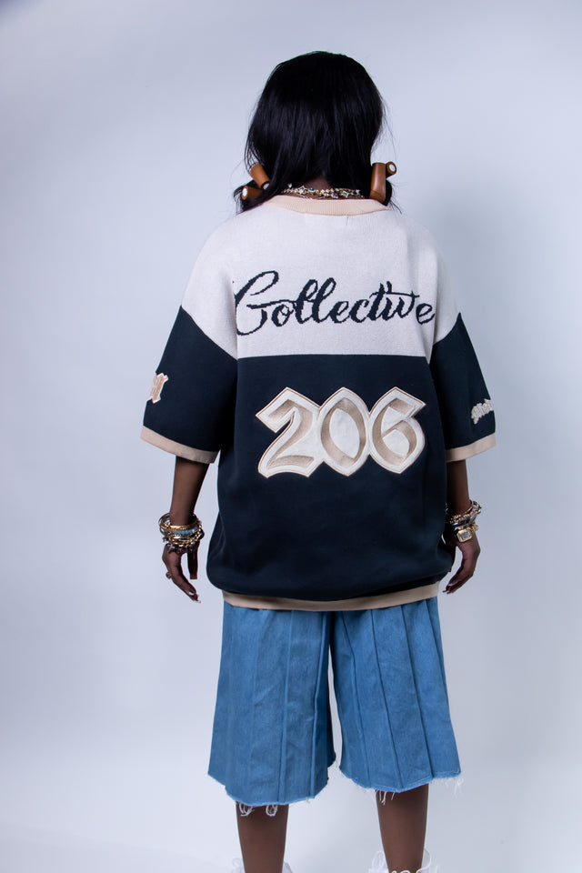 Model wearing a beige and navy Mediums Collective SEA 206 Knit V neck sports jersey with a SEA Velour embroidery design on a white background, Model wearing a beige and blue Mediums Collective Seattle 206 Knit V neck sports jersey with a SEA Velour embroidery design on a white background, MLB, mariners, Seattle v-neck, streetwear, sports knit jersey