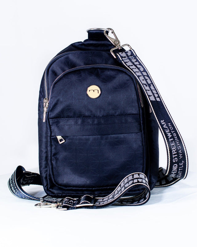 The Mediums Collective main is a super convenient, lightweight, and comfortable bag, meant for carrying you personal goods. It features our custom 22 collection fabric, an adjustable nylon belt for premium comfort on the shoulders, and multiple compartments for extra items. This is the bag that completes the fill fit. navy nylon, streetwear, bag, pack, metal buckle