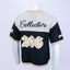 Mannequin wearing a beige and navy Mediums Collective SEA 206 Knit V neck sports jersey with a SEA Velour embroidery design on a white background. Baseball jersey with 'Collective' and '206' printed on a mannequin against a white background, beige and blue Mediums Collective Seattle 206 Knit V neck sports jersey with a SEA Velour embroidery design on a white background, MLB merch, mariners merch, Seattle v-neck, streetwear, sports knit jersey, near me