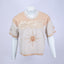 Mannequin wearing a beige and white Mediums Collective SEA 206 Knit V neck sports jersey with a SEA Velour embroidery design on a white background