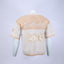 Mannequin wearing a beige and white Mediums Collective SEA 206 Knit V neck sports jersey with a SEA Velour embroidery design on a white background