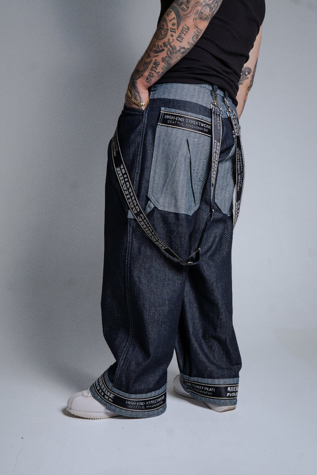 Person wearing a unique denim outfit with a plain background 