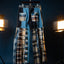 Plaid shirt and pants hanging on a stand against a dark background with studio lights.
