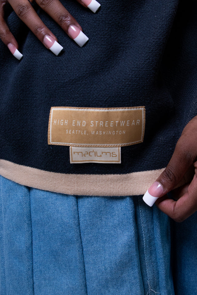 Model wearing a beige and navy Mediums Collective SEA 206 Knit V neck sports jersey with a SEA Velour embroidery design on a white background, Model wearing a beige and blue Mediums Collective Seattle 206 Knit V neck sports jersey with a SEA Velour embroidery design on a white background, MLB, mariners, Seattle v-neck, streetwear, sports knit jersey